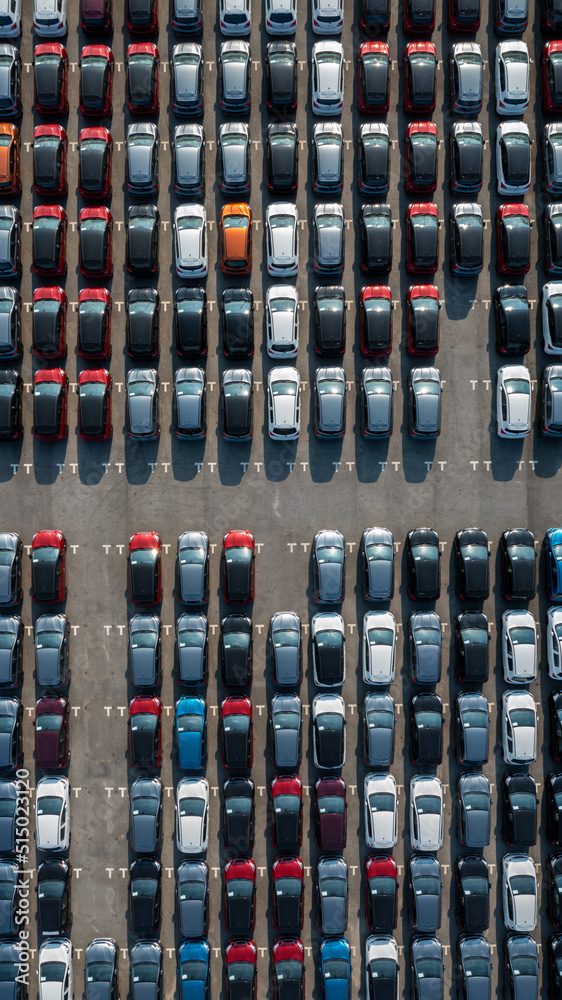 Aerial top view rows of new cars parked in distribution center on car factory, Automobile and automo