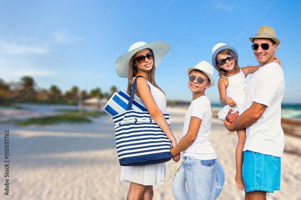 Happy young family walking on the beach