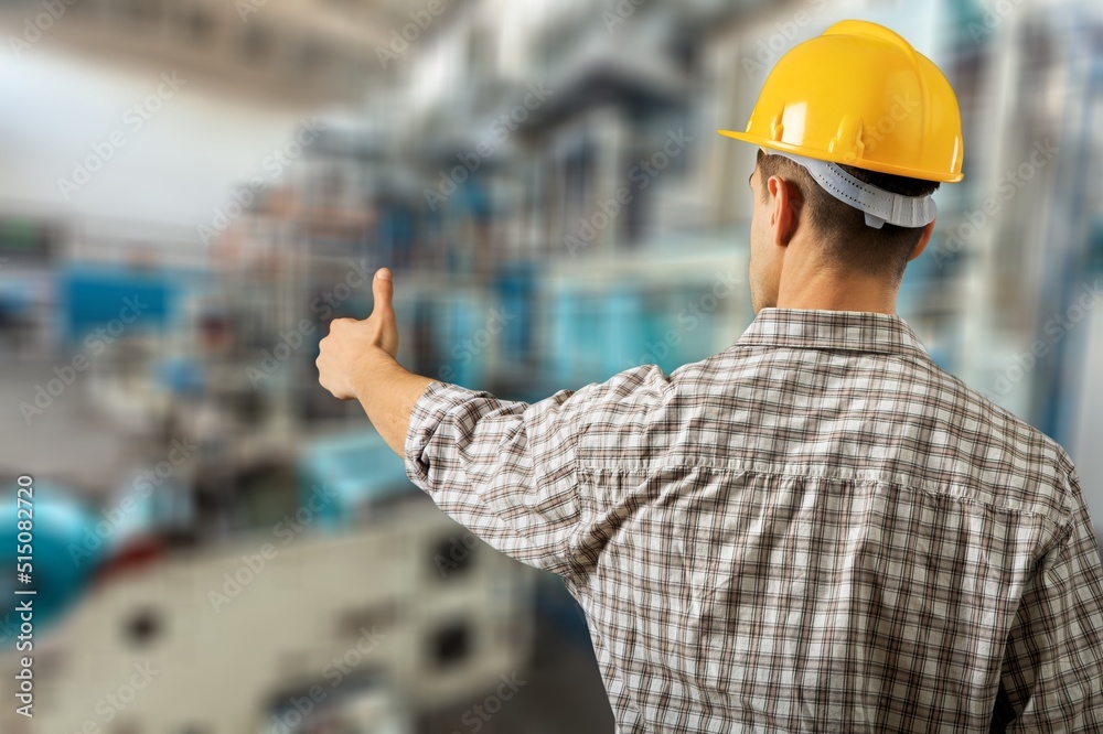 An engineering manager or mechanic worker doing routine check up in industrial factory