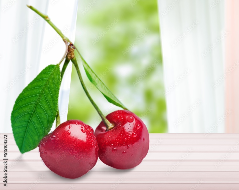 Tasty sweet fresh Cherries with leaves on the desk