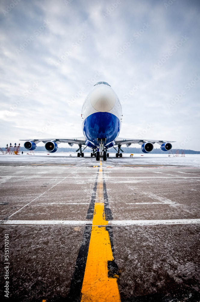 Airplane front fuselage with blue sky. Aircraft on runway of airfield