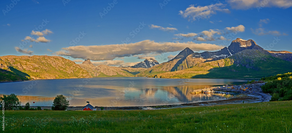 Countryside landscape in Nordland, Bodo, Norway with.glistening waters on a lake near a majestic mou