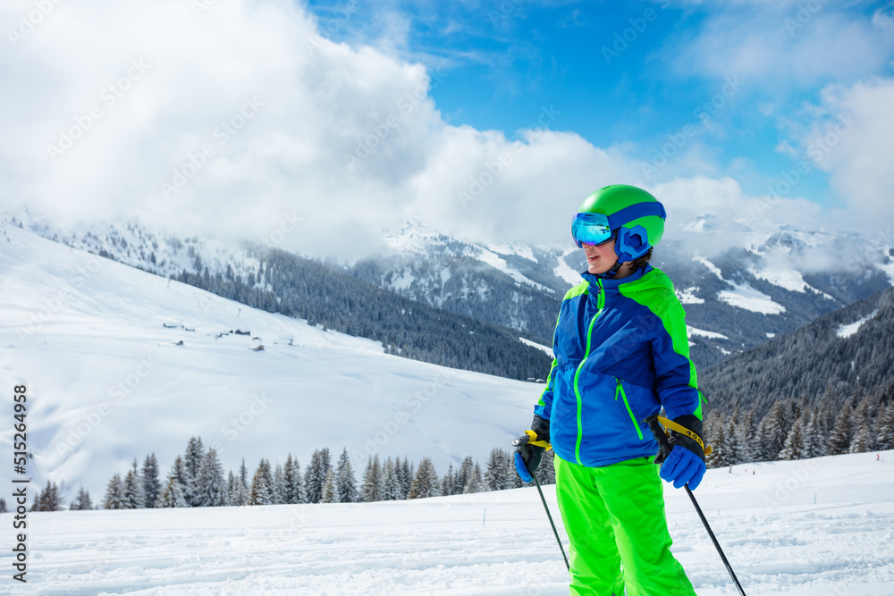 Close portrait of a preteen boy stand on the ski track