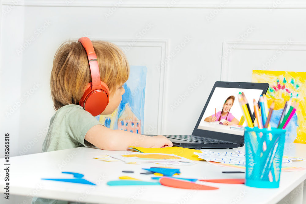 Distance education using laptop - little boy watch vidos