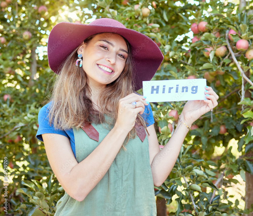 Female apple farmer hiring workers to help on her fruit farm during harvest. Portrait of happy young