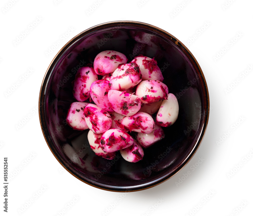 Pickled shiso garlic served on a plate set against a white background.