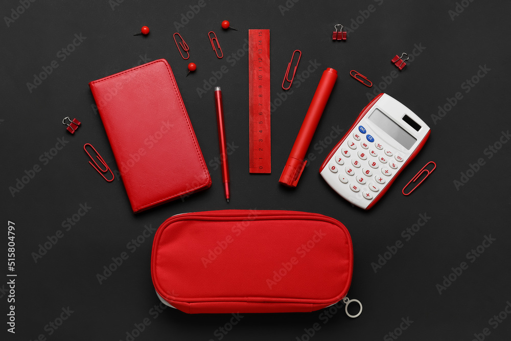 Pencil case and different stationery on dark background