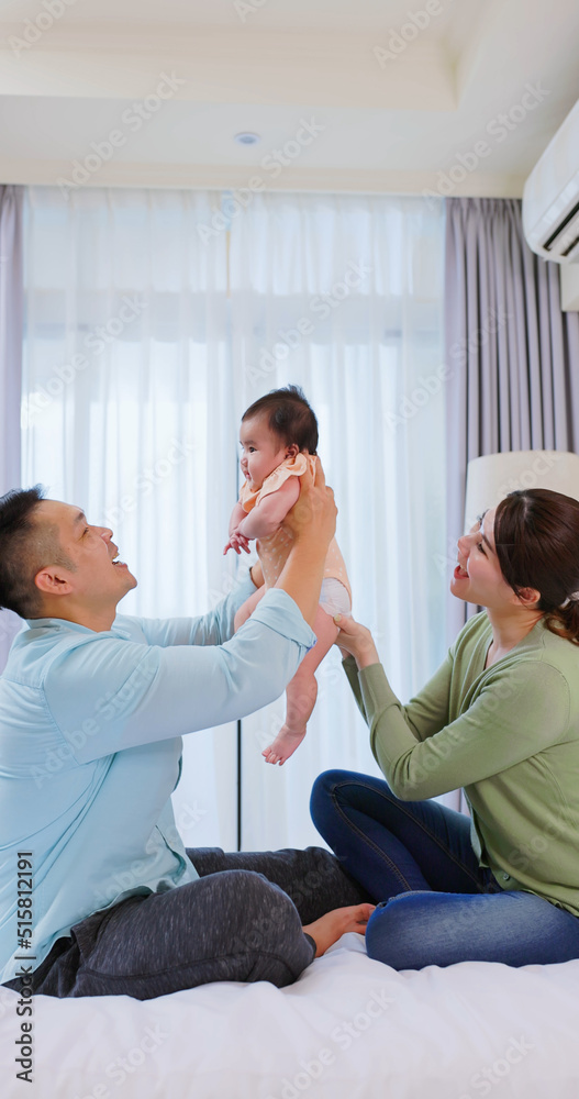 Happy family playing with baby