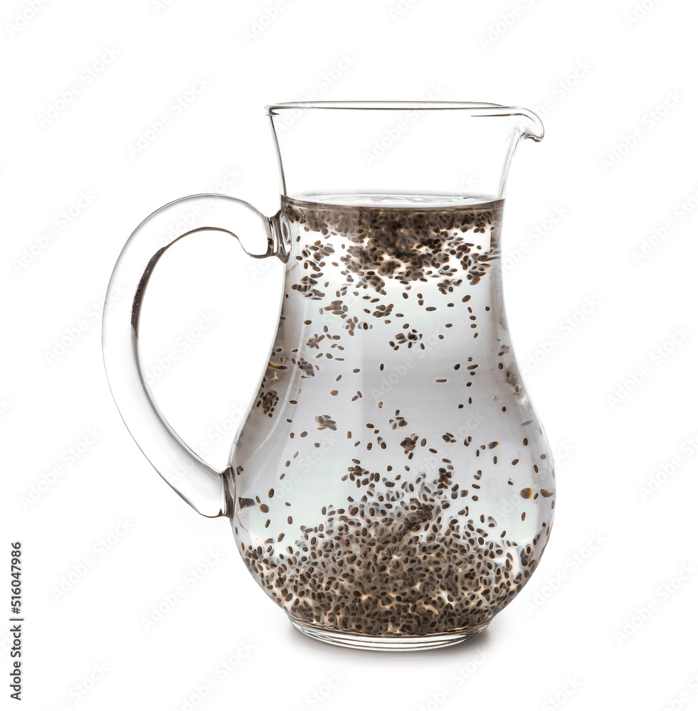 Glass jug of water with chia seeds on white background