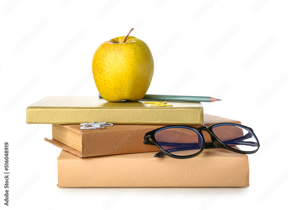 Books with apple, stationery and eyeglasses on white background