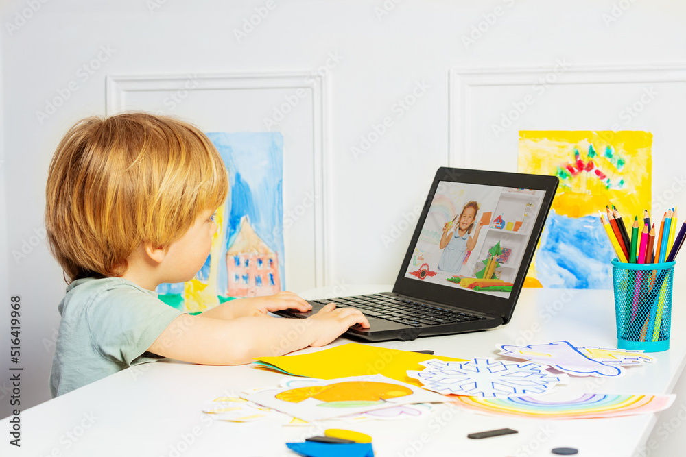 Smart little boy watch education videos on the laptop