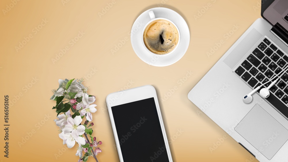 A smartphone with white screen mockup for workplace. Office accessories on table.