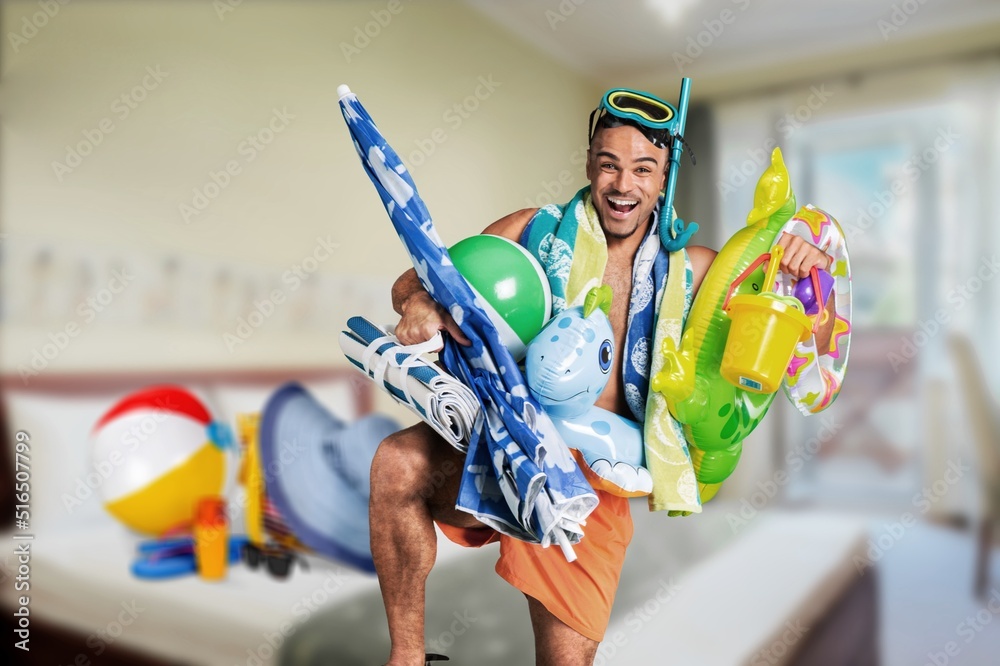 Funny crazy man pretends to be swimming at home in living room. Having fun imagining that he is on b