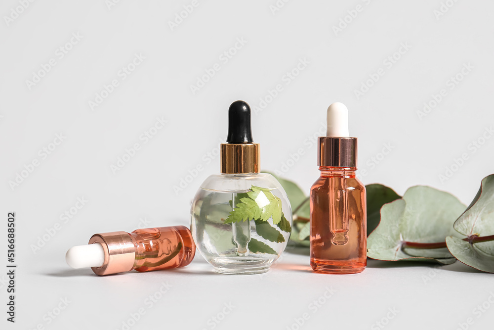 Bottles of natural serum on white background