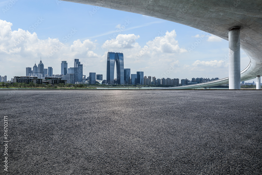 Cityscape of Suzhou City, Jiangsu Province, China. Asphalt road and modern city skyline scenery.