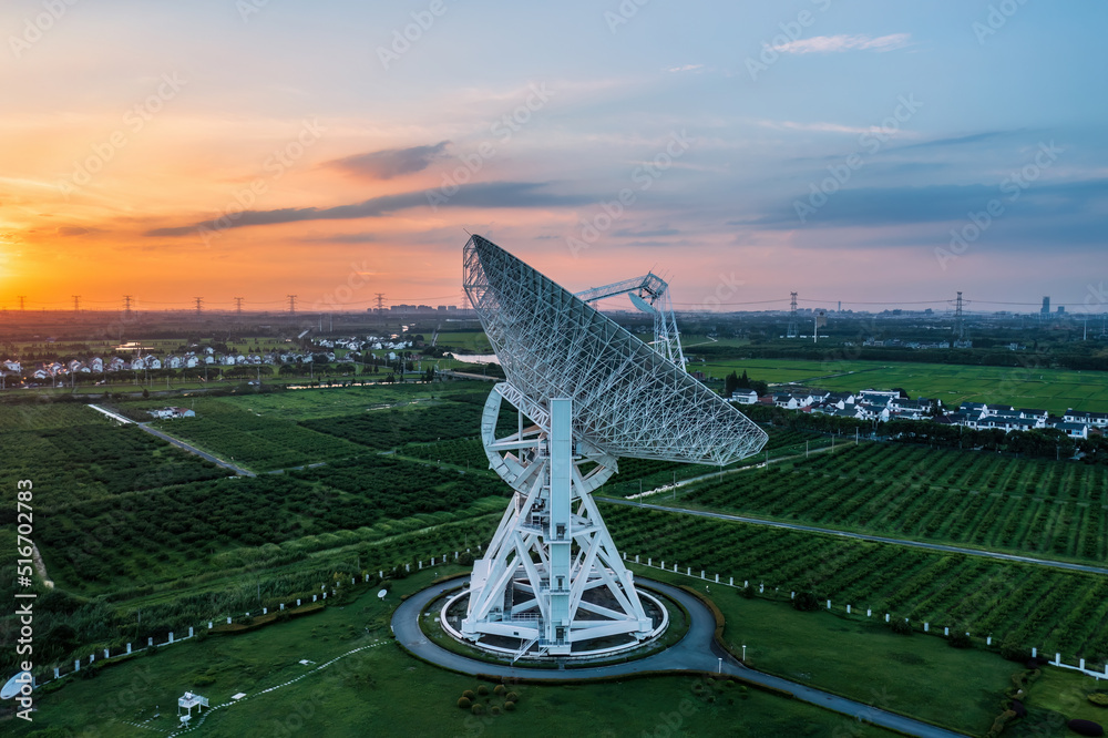 Aerial view of astronomical radio telescope and beautiful sky clouds at sunset