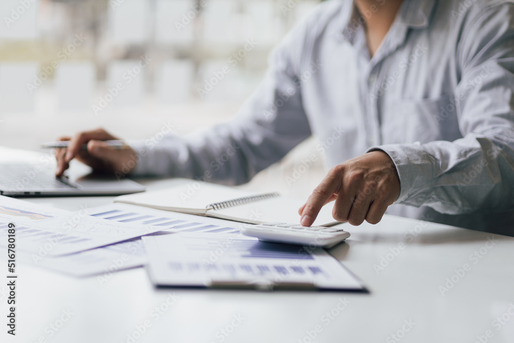 Accounting businessman working on laptop and analyzing real estate investment data, Financial and ta