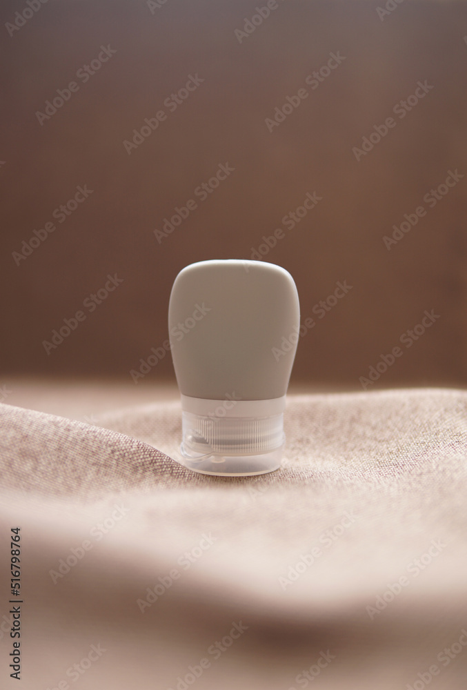 lotion tube mockup isolated on brown background.