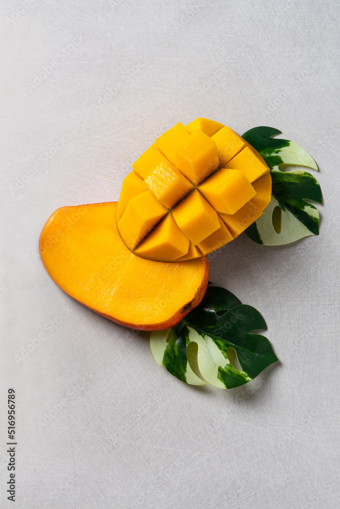 Mango background design concept. Top view Diced fresh mango fruit on gray table.