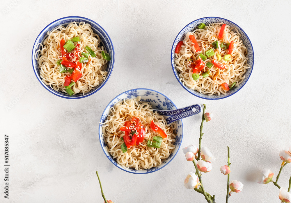 Bowl of tasty noodles on light background