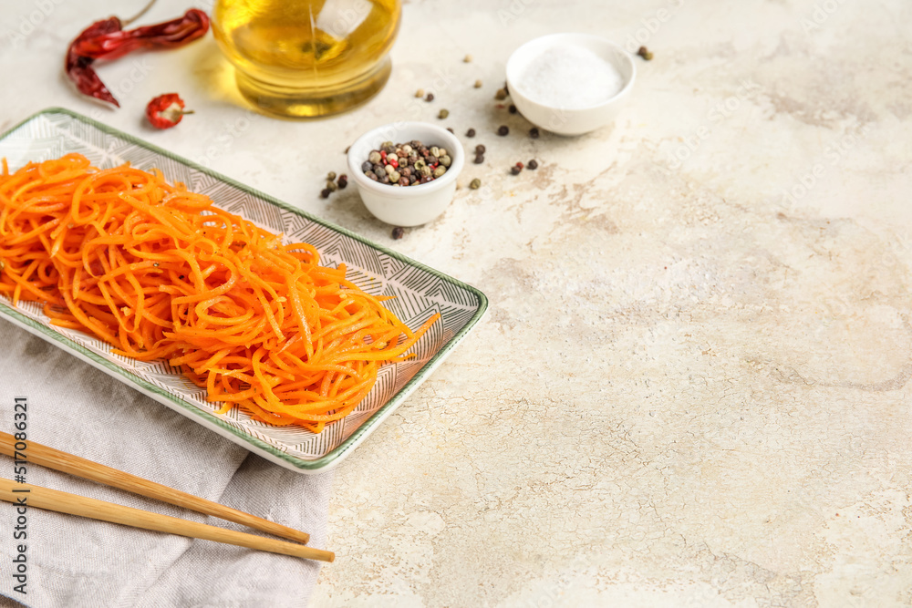 Bowl of korean carrot salad on light background