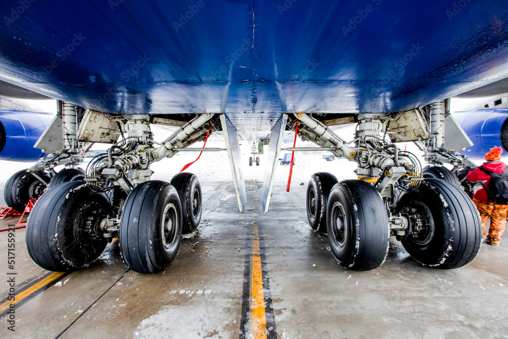 Front landing gear of a aircraft on the parking lot of the airfield