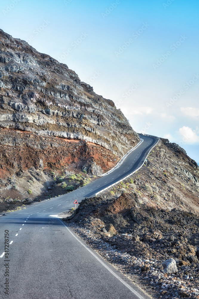 Empty road in the mountains with a clear blue sky. Landscape of a countryside roadway for traveling 