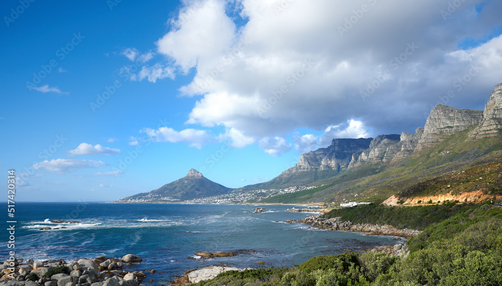 A beautiful sea landscape near a mountain with lush green plants growing outdoors in nature. Peacefu