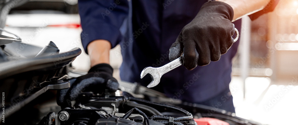 Car care maintenance and servicing, Close-up hand technician auto mechanic using the wrench to repai