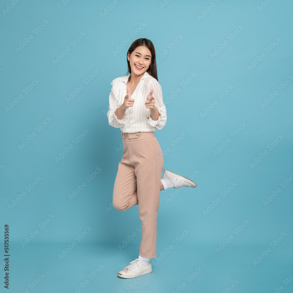 Young beautiful asian woman with smart casual cloth smiling with excitement pointing at camera isola