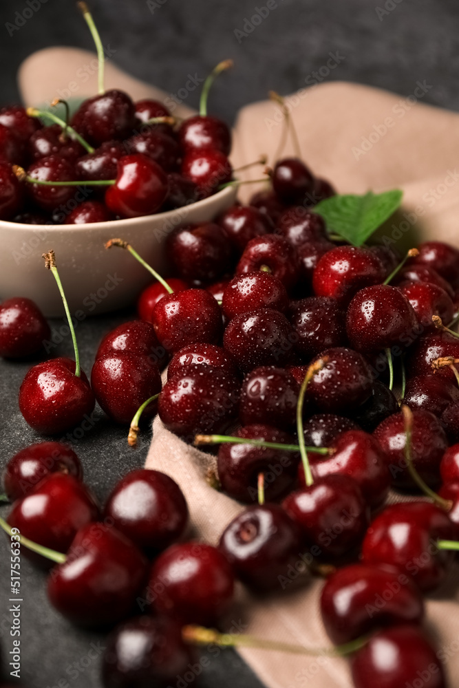 Ripe cherries with water drops on table, closeup