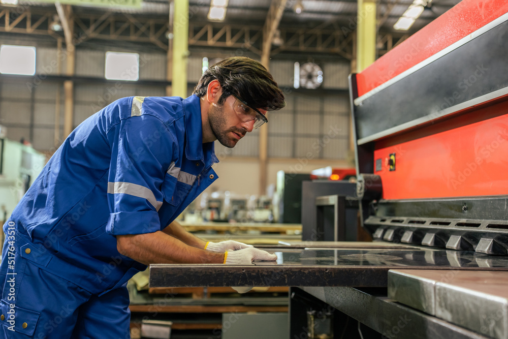 Caucasian handsome male industrial worker work in manufacturing plant. 