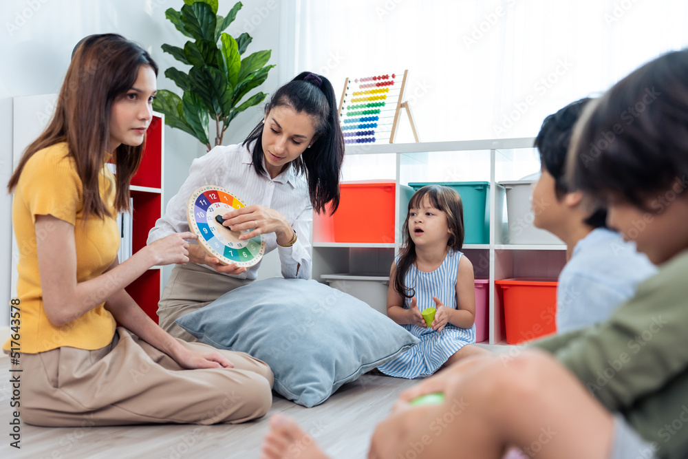 Caucasian beautiful young woman teacher teaching art to kids at school