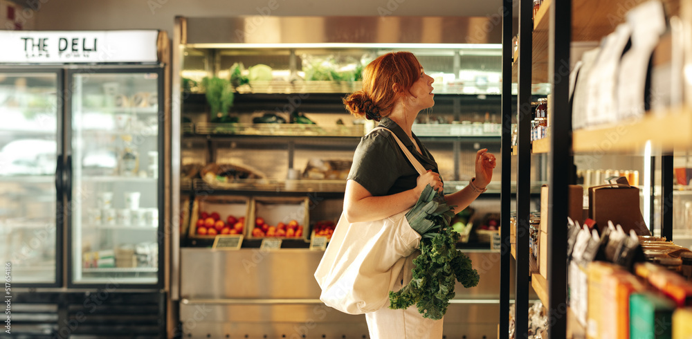 Young woman buying groceries in a supermarket