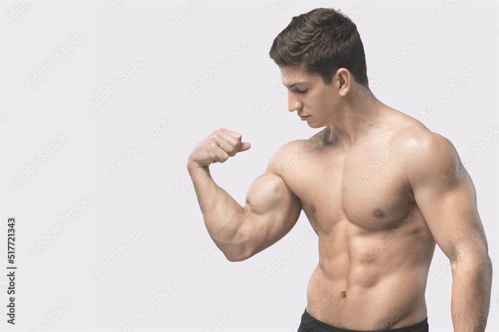 Workout and gym concept. Handsome man showing his muscles after sport exercises, flexing biceps