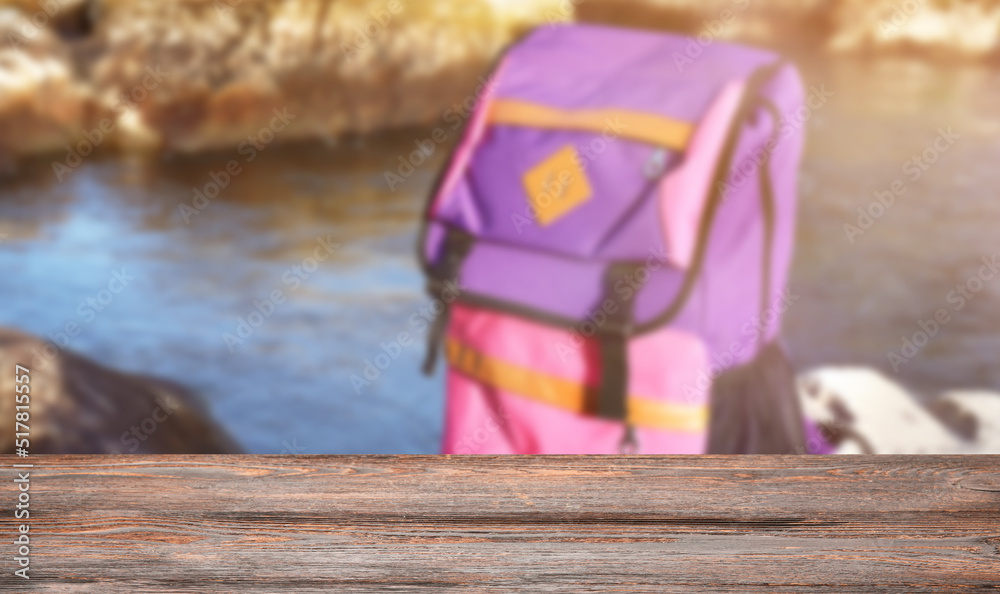 Tourists backpack on rock near mountain stream