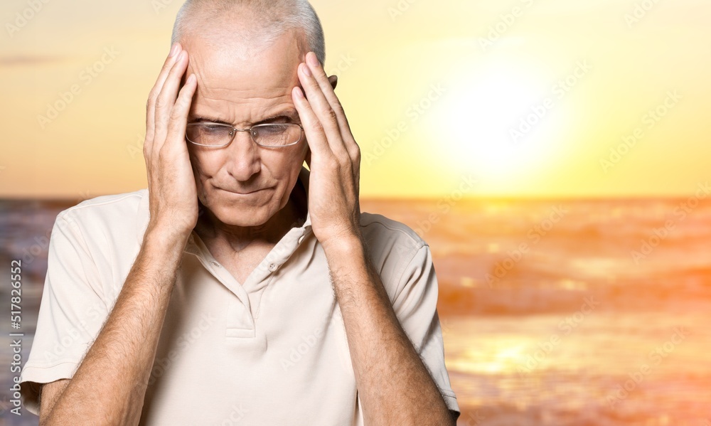 Tired person put hand on forehead at sunrise sun dawn over sea beach outdoor on pier seaside in summ