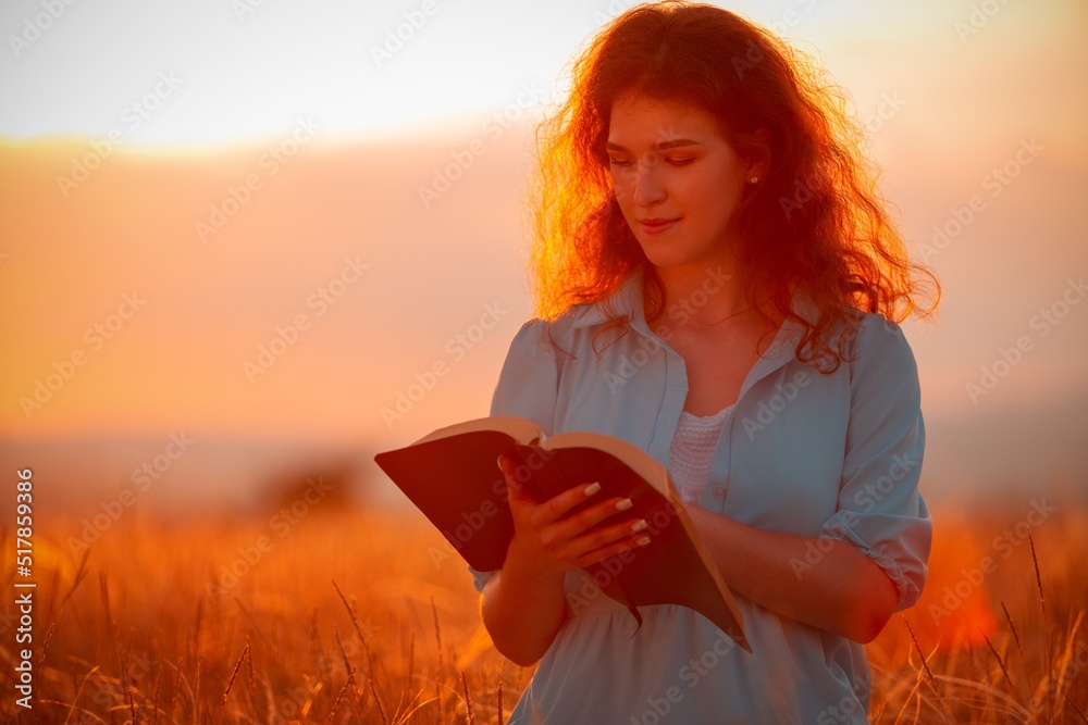 Christian woman holds bible book in her hands.