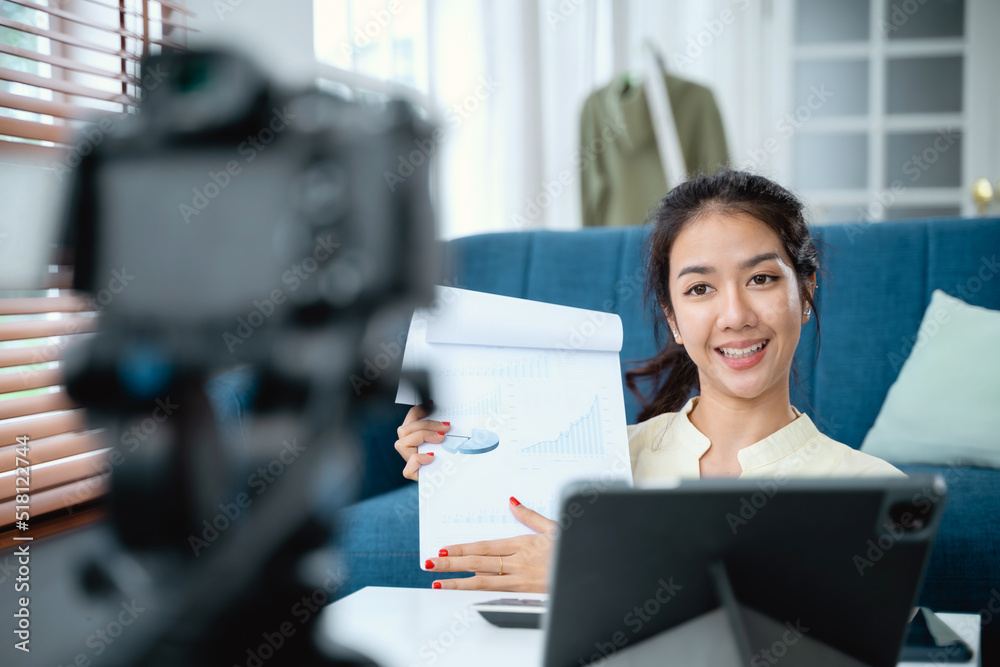 Young Asian business woman holding document meeting with team by video conference discuss online.