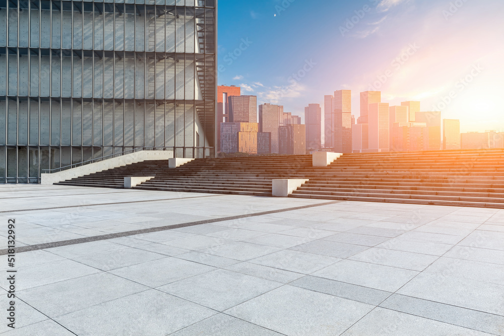 Empty square floor and city skyline with modern commercial buildings in Hangzhou at sunset, China.