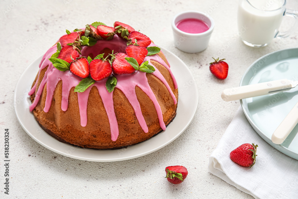 Plate with tasty strawberry cake on light table