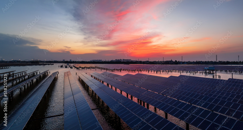 Solar power station at beautiful sunset. solar photovoltaic power station on water.