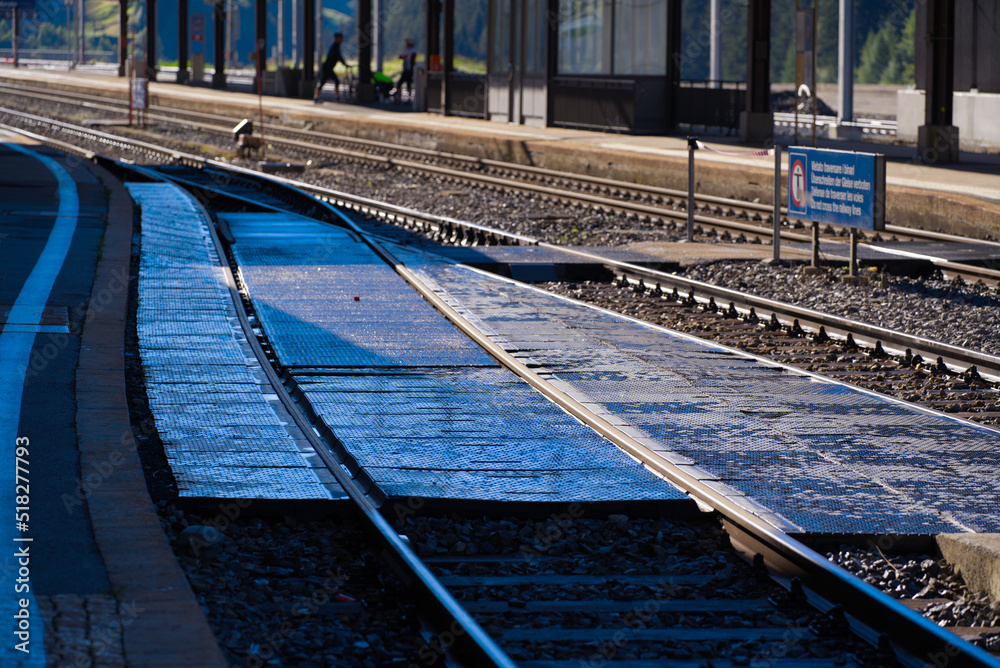 Railway station Airolo, Canton Ticino, with railway switch and platform on a sunny summer day. Photo