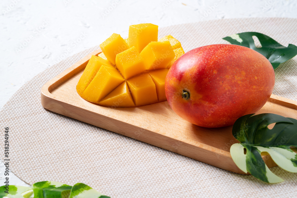 Mango background design concept. Top view Diced fresh mango fruit on white table.