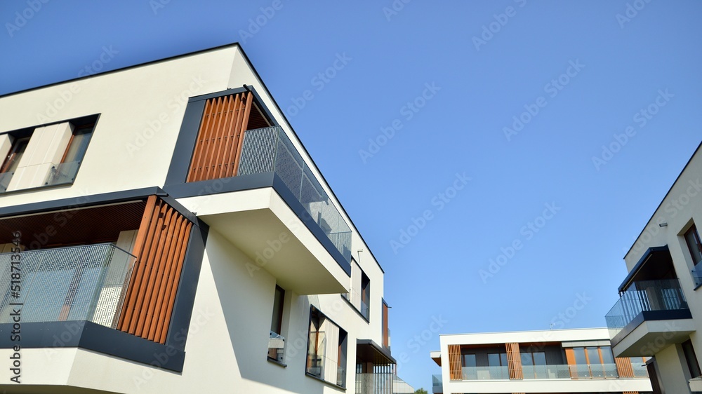 Exterior of new apartment buildings on a blue cloudy sky background. No people. Real estate business