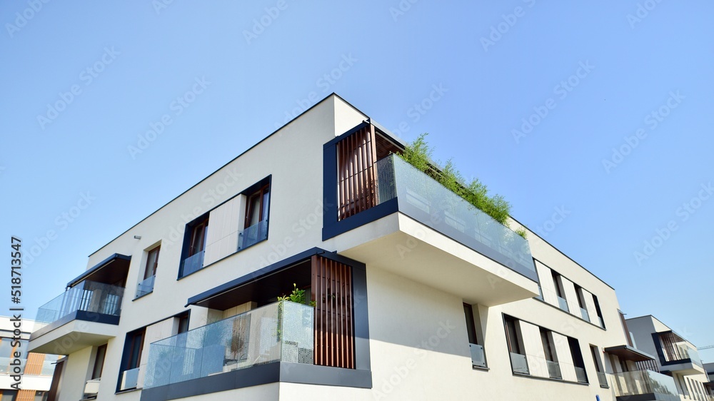 Exterior of new apartment buildings on a blue cloudy sky background. No people. Real estate business