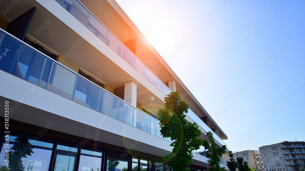 Exterior of new apartment buildings on a blue cloudy sky background. No people. Real estate business