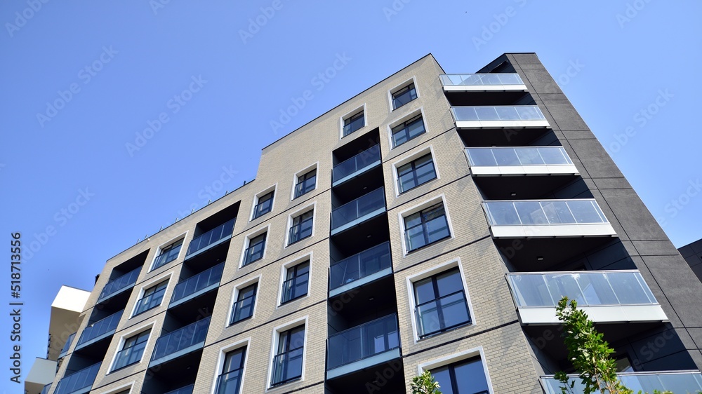 Exterior of new apartment buildings on a blue cloudy sky background. No people. Real estate business