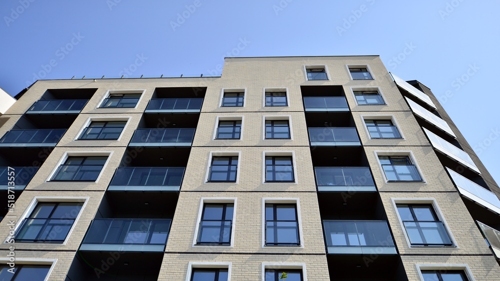 Exterior of new apartment buildings on a blue cloudy sky background. No people. Real estate business