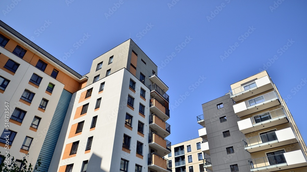 Exterior of new apartment buildings on a blue cloudy sky background. No people. Real estate business